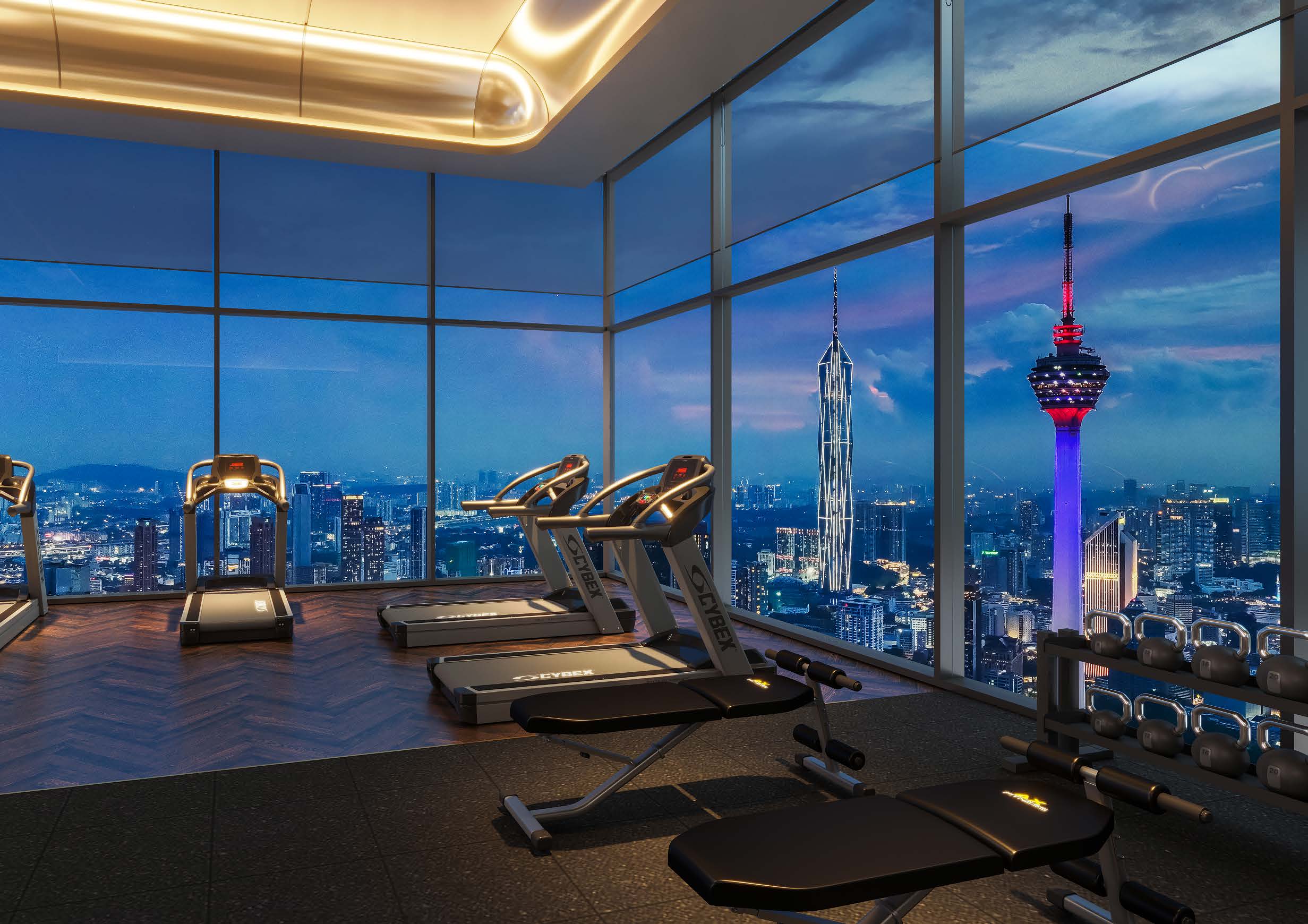 Sky gymnasium with floor-to-ceiling glass overlooking the KLCC skyline at dusk